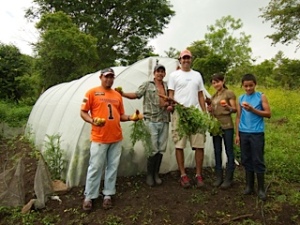 Tim Gibb, in white shirt, with one of the greenhouses in Las Palmas